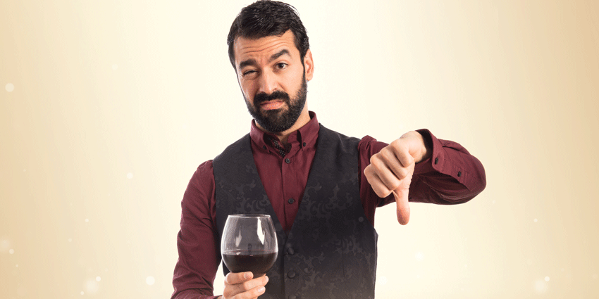 man giving wine a thumbs down